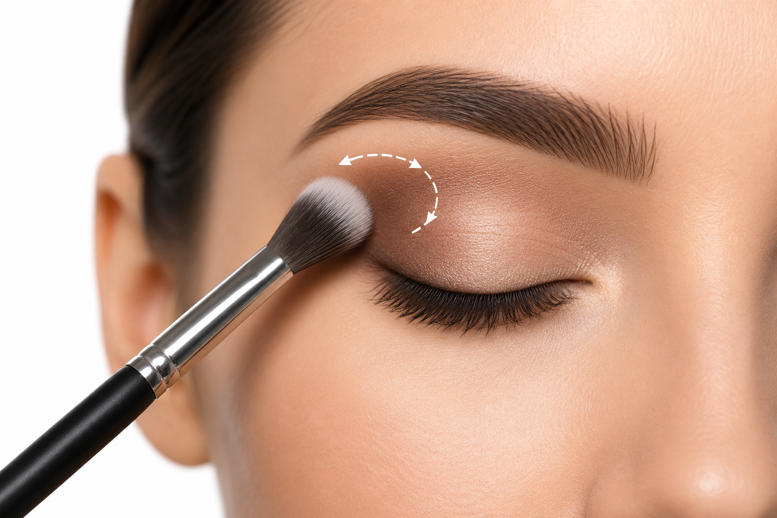 Blending eyeshadow using soft circular motions with a fluffy brush